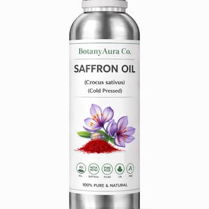 May include: A silver metal bottle of BotanyAura Co. Saffron Oil. The label features the text "SAFFRON OIL" and "(Crocus sativus) (Cold Pressed)". Below the text is a graphic of purple saffron flowers and red saffron threads. The bottle is labeled "100% PURE & NATURAL".
