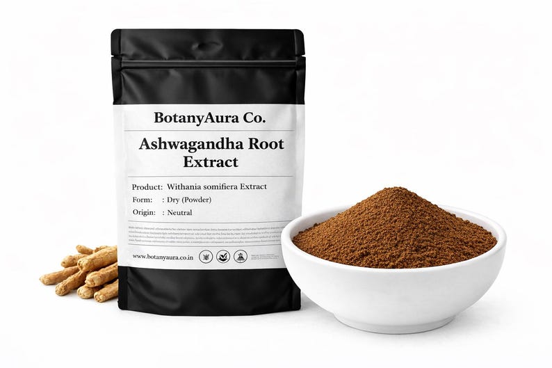 May include: A black pouch of Ashwagandha Root Extract powder from BotanyAura Co. is displayed next to a white bowl filled with brown powder and a small pile of dried roots. The product details are printed on the pouch.