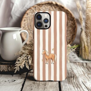 May include: A smartphone case featuring a pattern of vertical tan and white stripes. Centered on the case is a small illustration of a light brown horse with a white mane and tail, accompanied by two tiny, simple leaf icons.