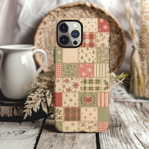 May include: A smartphone case featuring a patchwork design of various holiday-themed patterns in shades of red, green, and cream. The print includes motifs of snowflakes, pine trees, holly leaves, poinsettias, plaid squares, and a small red bow.