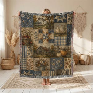 May include: A woven throw blanket featuring a patchwork design of country scenes, including a farmhouse, a barn, a basket of apples, two geese, pumpkins, and floral patterns in shades of blue, brown, and cream with a fringed edge on all sides.
