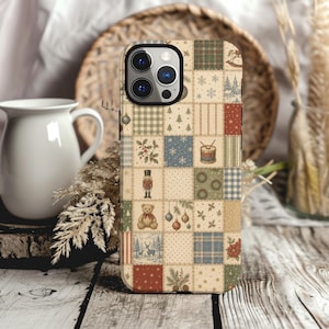 May include: A smartphone case featuring a patchwork design of various holiday-themed illustrations including a nutcracker, teddy bear, reindeer, Christmas trees, ornaments, drums, holly, and plaid patterns in muted red, green, blue, and cream tones.