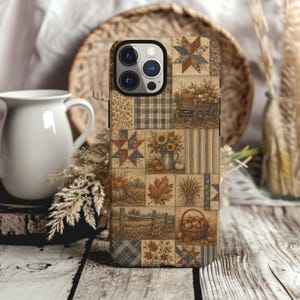 May include: A smartphone case featuring a patchwork design with various autumn-themed illustrations including a wooden wagon, sunflowers in a pitcher, pumpkins, maple leaves, wheat, a split-rail fence, and a basket filled with red apples.