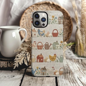 May include: A phone case with a light beige fabric-like background featuring a repeating pattern of embroidered-style motifs including small houses, chickens, watering cans, baskets, eggs, and flowers in muted tones of blue, red, yellow, and green.