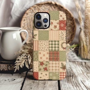 May include: A smartphone case featuring a patchwork design of various holiday-themed patterns in shades of red, green, and cream. The grid layout includes motifs of poinsettias, snowflakes, pine branches, plaid, stripes, and holly leaves.