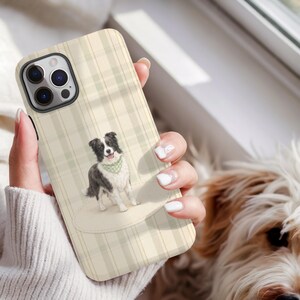 Peut inclure: Coque de téléphone à motif à carreaux crème et vert clair. L'étui présente une illustration à l'aquarelle d'un Border Collie noir et blanc portant un bandana vert. L'étui a une découpe pour l'appareil photo et un bord noir.