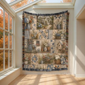 May include: A woven throw blanket featuring a patchwork design of garden scenes, including a greenhouse, birdhouse, bicycle, and various floral arrangements in blue, white, and tan tones. The blanket has a fringed edge with multicolored threads.