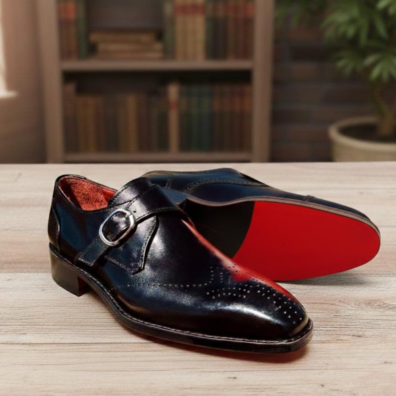 Handmade black leather single buckle monk strap shoes for men with classic formal design and metal buckle closure