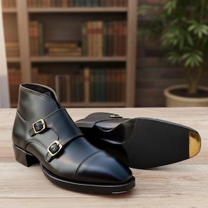 Handmade black leather double buckle monk strap shoes for men with classic formal design and metal buckle closure