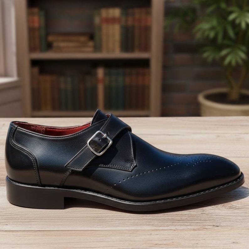 Handmade black leather single buckle monk strap shoes for men with classic formal design and metal buckle closure