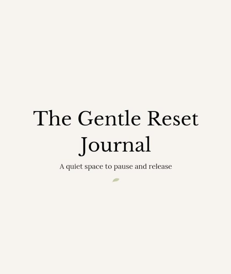 May include: A cream-colored background with the text "The Gentle Reset Journal" in a serif font. Below, the text reads "A quiet space to pause and release."
