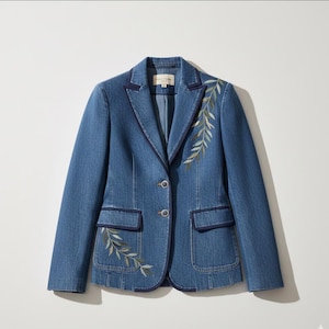 Könnte beinhalten: Ein Jeansblazer mit dunkelblauen Zierleisten und gestickten Blattdetails. Die Jacke hat zwei Vordertaschen und zwei Knöpfe. Der Blazer hat eine mittelblaue Waschung.