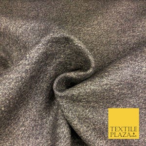 May include: A dark charcoal grey fabric with a heathered, speckled texture featuring interwoven light grey and white fibres. The material is folded to create soft, deep curves and shadows. A yellow square logo with the text TEXTILE PLAZA O&P.
