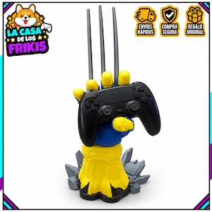 May include: A blue and yellow hand-shaped controller stand featuring three long silver claws extending upward. The hand is mounted on a gray rocky base and is currently holding a black wireless video game controller in its grip.