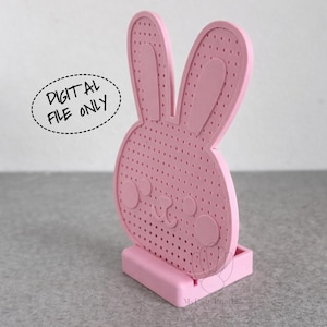 May include: A pink bunny-shaped decorative item with a perforated design. The bunny has large ears and a small face. The item is standing on a small rectangular base. Text in a speech bubble reads "DIGITAL FILE ONLY".