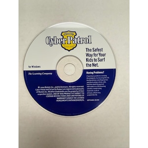May include: A CD-ROM for Windows featuring the "Cyber Patrol" logo with a yellow shield. The disc's text reads "The Safest Way for Your Kids to Surf the Net." It includes copyright information from The Learning Company.