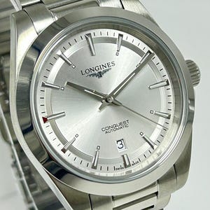 Refurbished Longines Conquest Silver Dial With Date Indicator Automatic Movement Men's Wrist Watch With Stainless Steel Band.