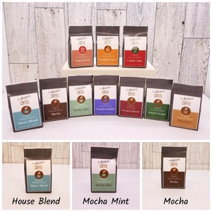 May include: A collection of 12 small bags of organic coffee, each with a different flavor. The flavors include House Blend, Mocha, Mocha Mint, French Vanilla, French Roast, Irish Cream, Hazelnut, Gingerbread, Pumpkin Spice, and Candy Cane.
