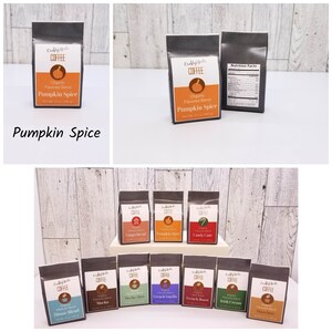 May include: A collection of 10 small bags of coffee, each with a different flavor. The flavors include Pumpkin Spice, Gingerbread, Candy Cane, Mocha Mint, Mocha, French Vanilla, French Roast, Irish Cream, Hazelnut, and House Blend. Each bag is labeled with the flavor and the words "Custy Gals Coffee".