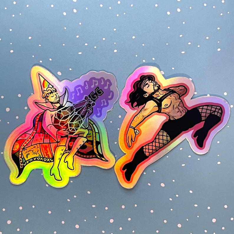May include: Two holographic stickers featuring illustrated figures. The left sticker shows a person in a rainbow party hat and cape holding a geometric object with the letters GG. The right sticker depicts a person in a harness and fishnet stockings.