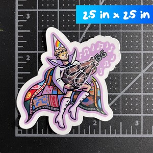 May include: A die-cut sticker measuring 2.5 inches by 2.5 inches featuring a person in a white cone hat with a rainbow, a white cape with a colorful patchwork pattern, and white boots, holding a brown roasted turkey with musical notes nearby.