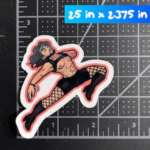 May include: A die-cut sticker featuring a stylized illustration of a person with long dark hair, wearing a black harness, black shorts, fishnet stockings, and black boots, measuring 2.5 inches by 2.375 inches as indicated by the grid background.