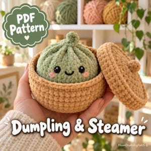 May include: A crochet PDF pattern for a dumpling and steamer. The image shows a light green, plush, round dumpling with a smiling face and pink cheeks inside a tan, circular, lidded crochet steamer basket. The text reads PDF Pattern and Dumpling & Steamer.