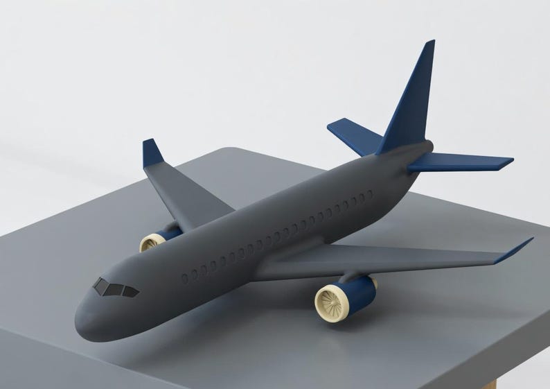 May include: A gray airplane model with blue accents on the tail and wings, and cream-colored engine details. The toy airplane is positioned on a gray surface, showcasing its design.