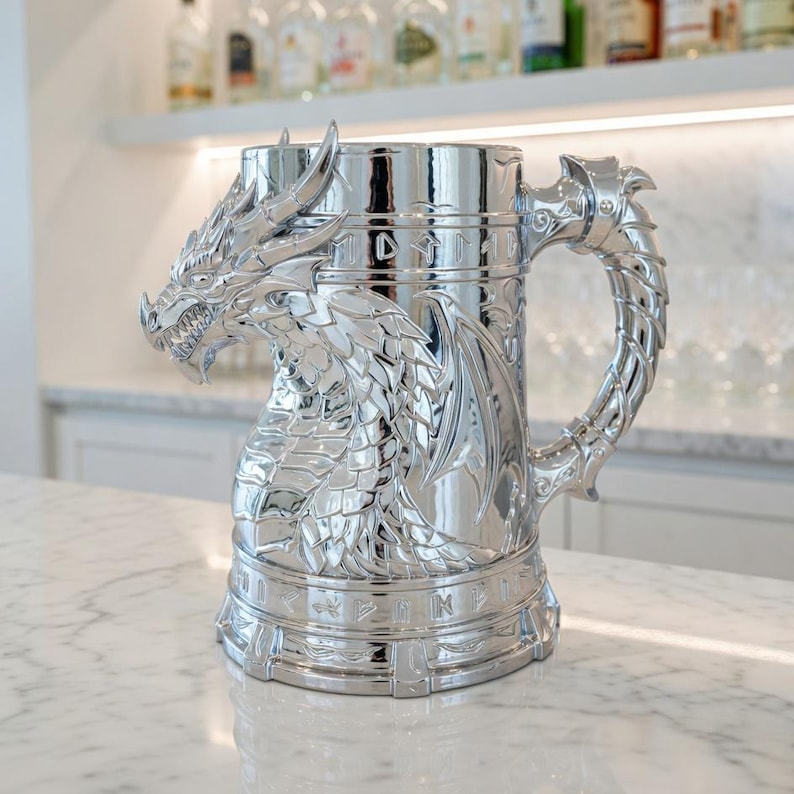 A professional collage showcasing over 20 unique 3D printable STL models for beer mugs and can holders. The image features high-detail designs including a horned Minotaur with gold accents, a gothic skull wearing aviator goggles, and a steampunk gas mask style tankard with copper pipes. The background displays various mythical, viking, and dark fantasy themed mugs in metallic silver and bronze finishes. Large yellow and blue 3D text in the center reads '20+ Can Holder & Beer Mug STL'.