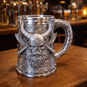 A professional collage showcasing over 20 unique 3D printable STL models for beer mugs and can holders. The image features high-detail designs including a horned Minotaur with gold accents, a gothic skull wearing aviator goggles, and a steampunk gas mask style tankard with copper pipes. The background displays various mythical, viking, and dark fantasy themed mugs in metallic silver and bronze finishes. Large yellow and blue 3D text in the center reads '20+ Can Holder & Beer Mug STL'.