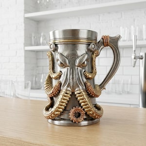 A professional collage showcasing over 20 unique 3D printable STL models for beer mugs and can holders. The image features high-detail designs including a horned Minotaur with gold accents, a gothic skull wearing aviator goggles, and a steampunk gas mask style tankard with copper pipes. The background displays various mythical, viking, and dark fantasy themed mugs in metallic silver and bronze finishes. Large yellow and blue 3D text in the center reads '20+ Can Holder & Beer Mug STL'.