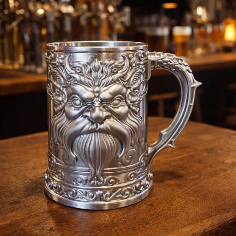 A professional collage showcasing over 20 unique 3D printable STL models for beer mugs and can holders. The image features high-detail designs including a horned Minotaur with gold accents, a gothic skull wearing aviator goggles, and a steampunk gas mask style tankard with copper pipes. The background displays various mythical, viking, and dark fantasy themed mugs in metallic silver and bronze finishes. Large yellow and blue 3D text in the center reads '20+ Can Holder & Beer Mug STL'.