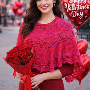 May include: A woman wearing a pink and red knitted shawl, holding a bouquet of red roses and a heart-shaped balloon that says "Happy Valentine's Day". The shawl has a lace-like pattern.