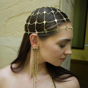 festival ready gold hair chain crown with mirror embellishments and fluid chain earrings bold fashion styling  delicate gold lattice headpiece draped across scalp with matching multi chain earrings lightweight statement jewelry  editorial style gold head jewelry with structured chain pattern and long fringe earrings modern bohemian look  bridal hair chain accessory with geometric mirror shapes and flowing chain earrings soft romantic styling