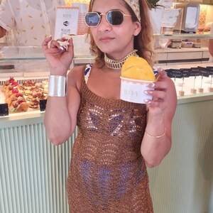 Woman wearing a handcrafted mirror work bandana with gold and turquoise embroidery
	2.	Side angle of embroidered headband under a beach umbrella, perfect for summer styling
	3.	Close-up of gold bangles and mirror work headband paired with chandelier earrings
	4.	Relaxing beach shot highlighting the statement mirror work headband and jewelry ensemble