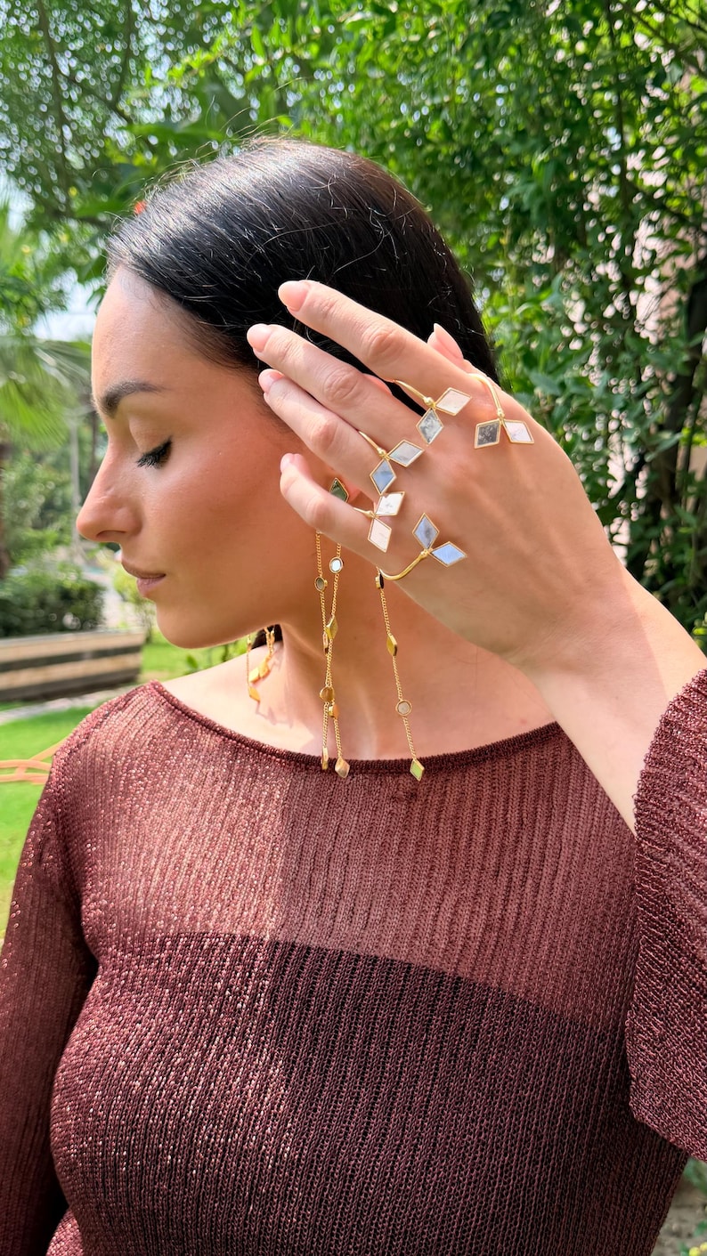 Artistic brass finger and palm cuff
Fashionable festival hand jewelry piece