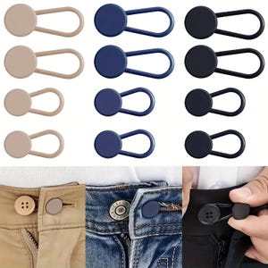 May include: Button extenders in beige, navy blue, and black. Each extender features a button head and a looped elastic band. The image demonstrates their use on trousers, offering additional waist space. Measurements are in cm.