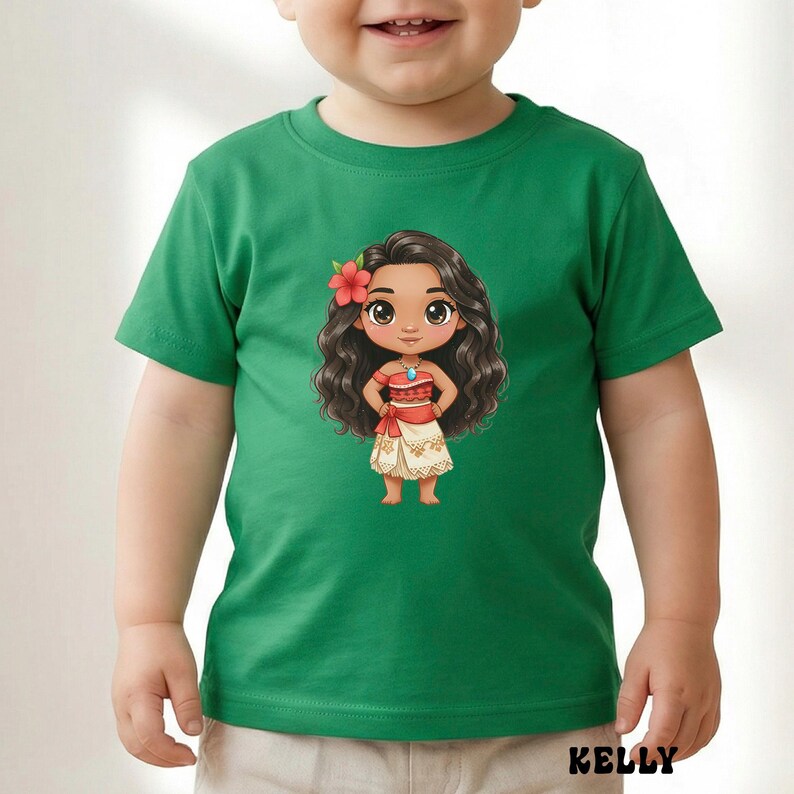 May include: Green toddler t-shirt featuring a cartoon illustration of a Polynesian girl with long, dark wavy hair, a red flower, and a traditional outfit. The shirt has the word "KELLY" printed at the bottom.