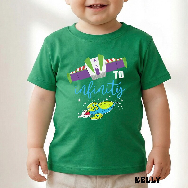 May include: A green t-shirt featuring a graphic of a spaceship and the phrase "TO infinity" in blue script. The design includes a spaceship and stars. The word "KELLY" is printed in the bottom right corner.