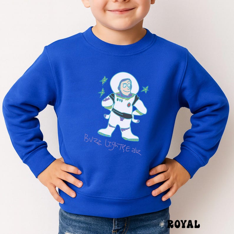 May include: Royal blue sweatshirt featuring a cartoon illustration of Buzz Lightyear in a spacesuit. The design includes the text "Buzz Lightyear" in a handwritten style. The sweatshirt is a solid royal blue color.