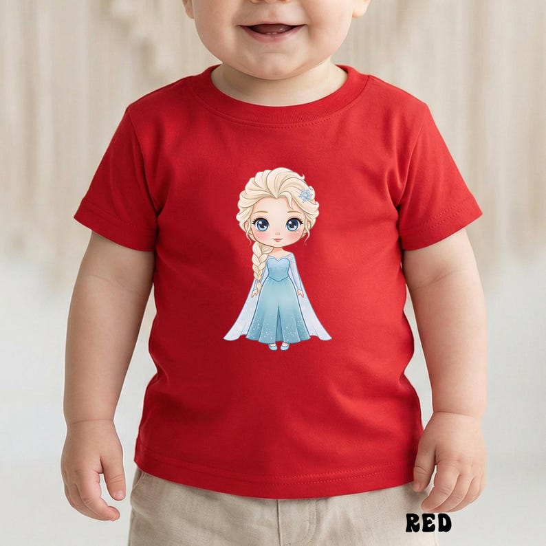 Puede incluir: Una camiseta roja para ni&ntilde;os peque&ntilde;os con una ilustraci&oacute;n de dibujos animados de una princesa con un vestido azul. La princesa tiene el pelo rubio y un accesorio para el pelo de flor azul. La palabra "RED" est&aacute; impresa en negro en la parte inferior de la camiseta.