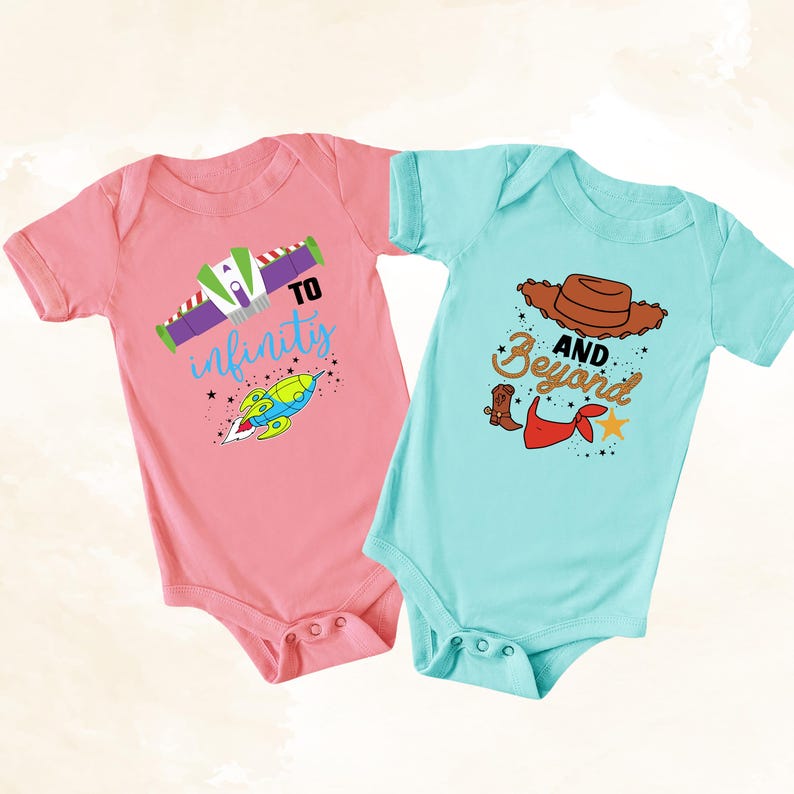 May include: Two baby onesies, one pink and one light blue. The pink onesie has a rocket ship graphic with the text "To infinity". The light blue onesie has a cowboy hat, boots, and the text "And Beyond".