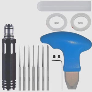May include: A set of precision tools, including a black and silver handle, several thin metal picks labeled with measurements from 0.1mm to 2.0mm, and a blue-handled tool. Also includes two rolls of tape, labeled 3mm and 6mm.