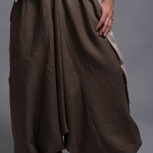 Brown linen pants with a loose, flowing fit. The pants have a wide leg and a gathered waist.