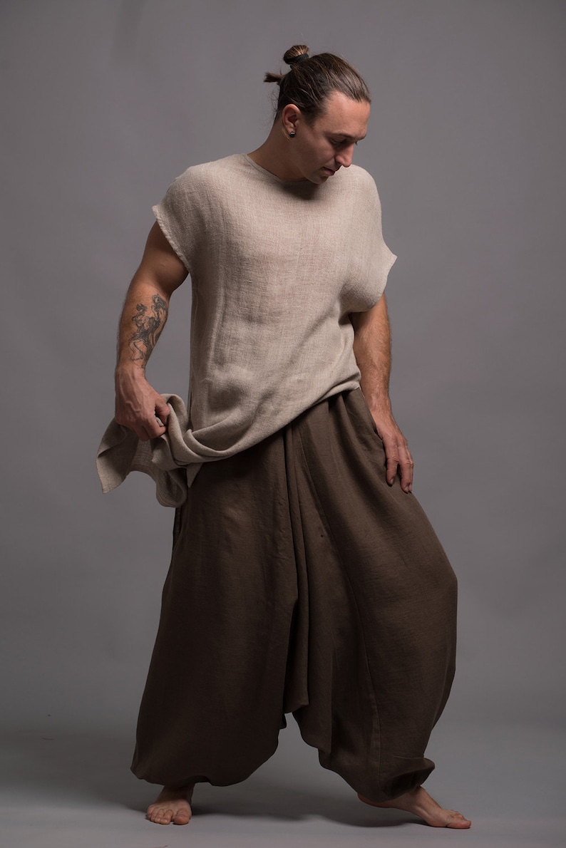 A person wearing a light brown linen top with a loose fit and brown linen pants with a wide leg.