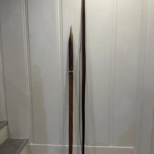 May include: A rustic wooden sign with the text "Welcome to our home" in white lettering. The sign has a distressed finish and a simple, inviting design, ideal for a hallway or porch.