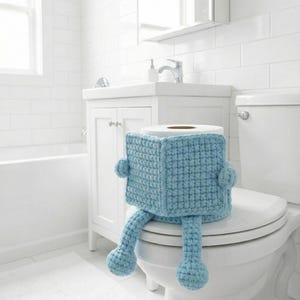 May include: A white ceramic mug with a black handle and the text "But First, Coffee" in a black, handwritten-style font. The mug is on a white surface.