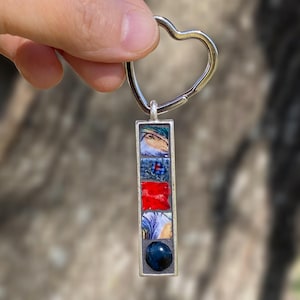 Può includere: Una tazza di ceramica bianca con manico nero e la scritta "But First, Coffee" in grassetto nero. La tazza è esposta su una superficie bianca. La tazza sembra contenere circa 355 ml.