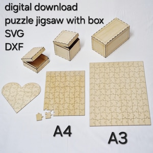 May include: A collection of wooden jigsaw puzzles and boxes. The puzzles are in heart, A4, and A3 sizes. The boxes are rectangular with decorative edges. The image includes the text "digital download puzzle jigsaw with box SVG DXF".