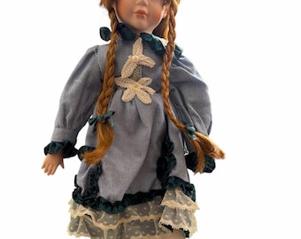 Doll 17” porcelain doll in a cute blue dress she has no markings